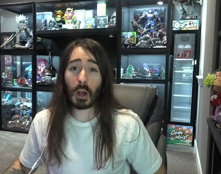 Charles's dopey face in front of scale figures and a Goof Juice fridge